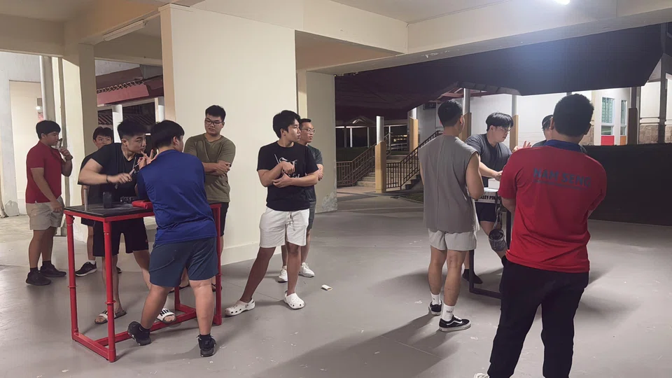 “The Sweaty People” gather at an HDB void deck for training sessions once a week.