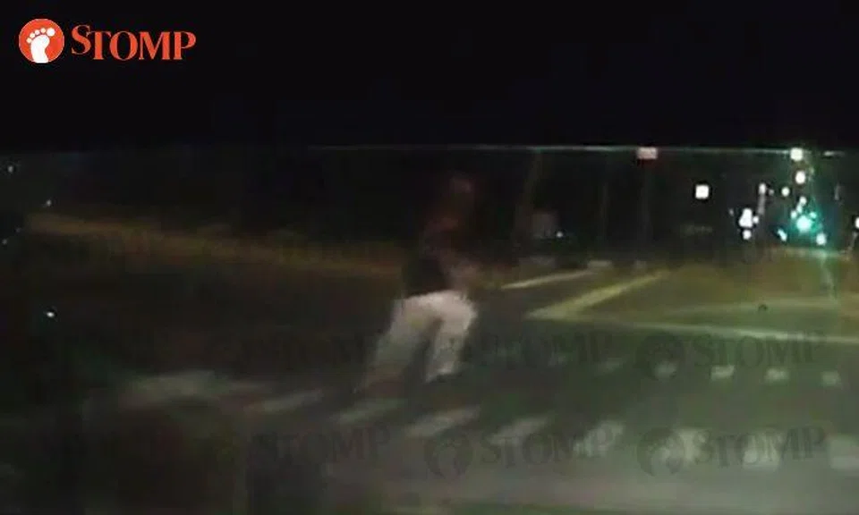 Is it deliberate? Woman keeps trying to dash in front of oncoming cars in Yio Chu Kang