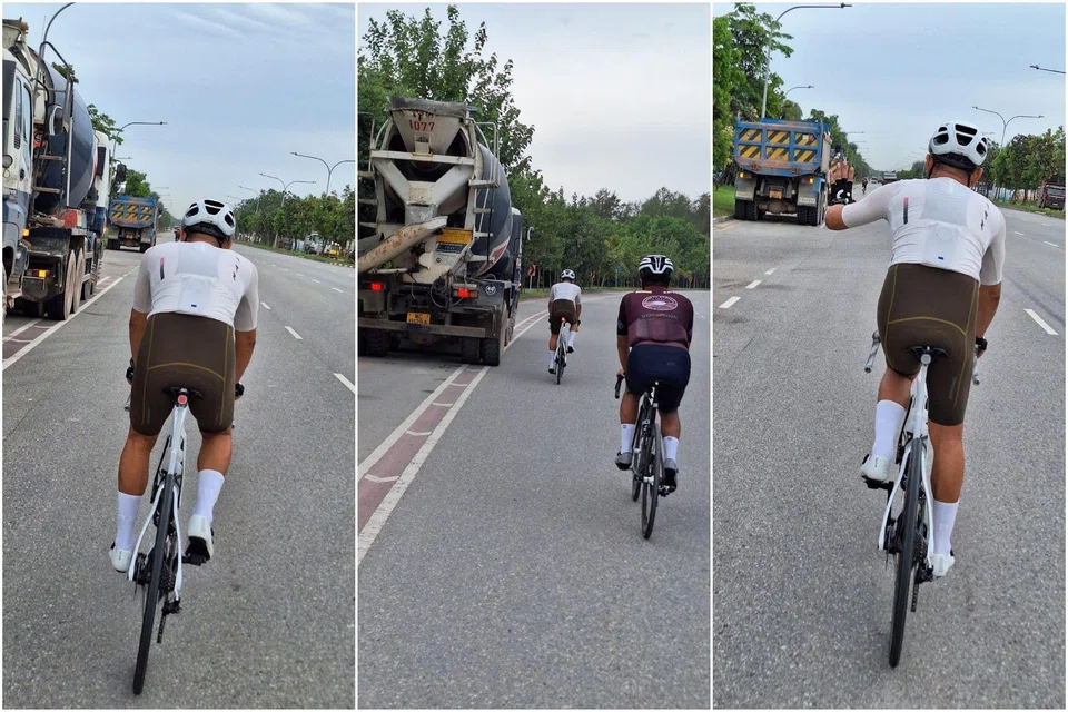 Cyclists manoeuvring traffic with heavy vehicles parked in the cycling lane, along Tanah Merah Coast Road, on the morning of May 30.