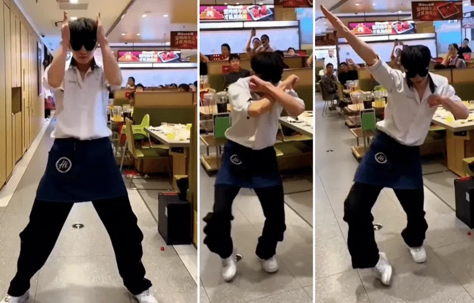 A Haidilao employee performing the Ke Mu San.