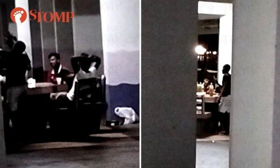 Taken furtively from behind the pillars in the void deck, the videos show about half a dozen men having a raucous time as they sat around a table with bottles on it. 