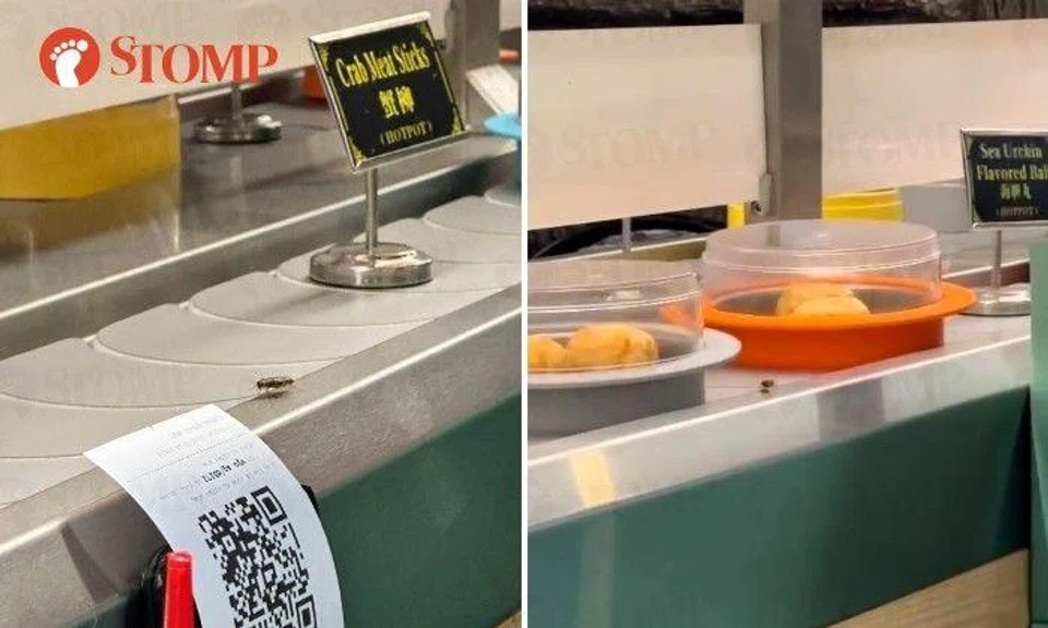 Stomper Traww shared a three-second video of the insect crawling along the side of the food conveyor belt beside the covered dishes.