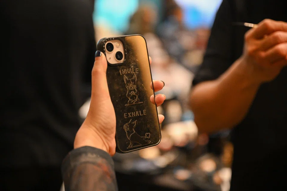 Ms Lim's phone cover features a dog in yoga poses. She starts each day with a yoga session at home.