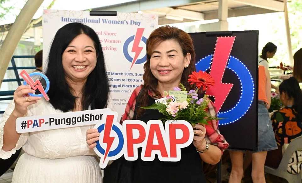 Pasir Ris-Punggol GRC MP Yeo Wan Ling (left) and a resident at an event marking International Women's Day on March 30.