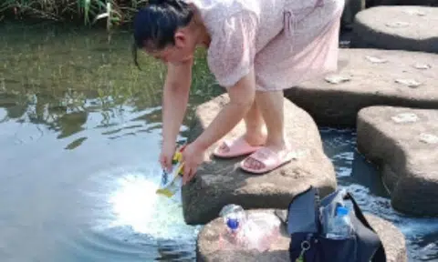 The woman allegedly said the milk powder had expired before emptying the contents of the packet into the pond.