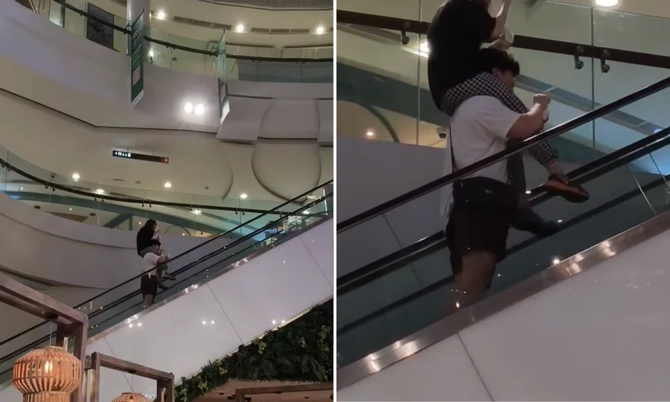 A woman sits on her boyfriend’s shoulders while riding an escalator in a viral video posted on Nov 23.