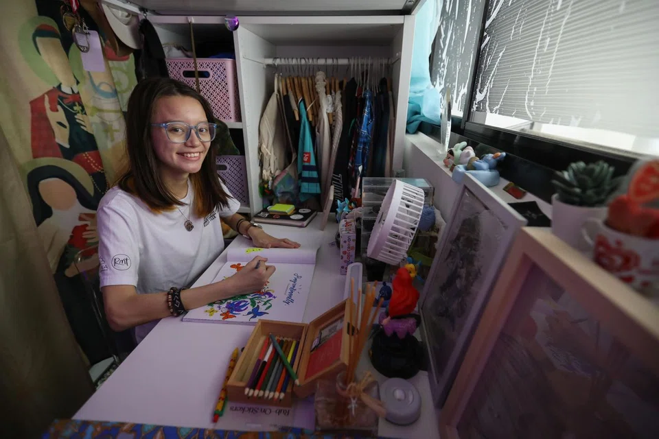 Ms Shelley at the desk of her cosy bedroom in her family's Punggol flat.