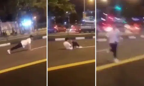 Youth dashes into middle of the road to do push-ups, sit-ups before getting horned at by oncoming traffic