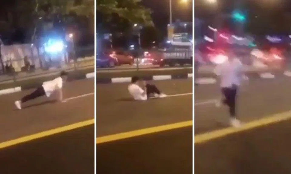 Youth dashes into middle of the road to do push-ups, sit-ups before getting horned at by oncoming traffic