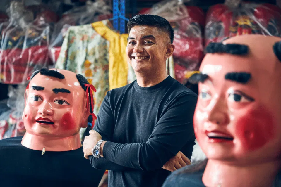 Mr Ahmad Zahid Isnin stands among the big-headed doll costumes that he wears as a performer at Chinese funeral processions, embracing a role few outsiders have taken on.