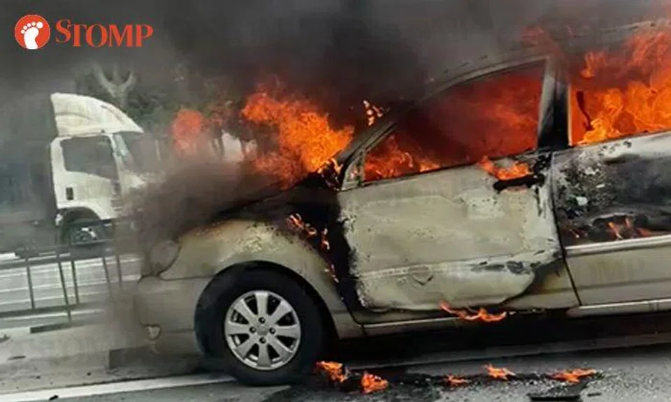 1 taken to hospital after flames and smoke engulf car at Woodlands junction