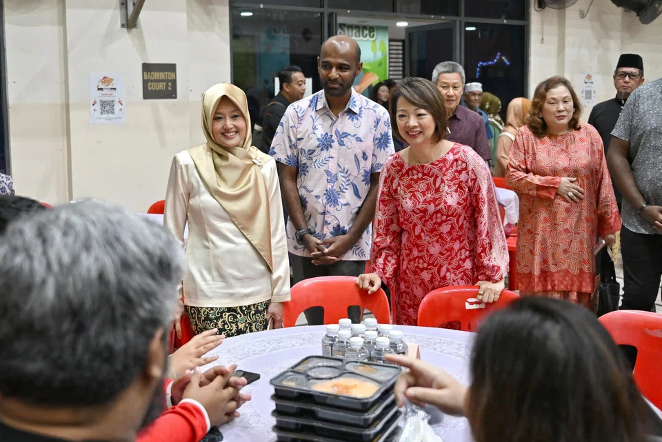 (From left) Minister of State for Health and Digital Development and Information Rahayu Mahzam, second advisor to Jurong GRC grassroots organisations Hamid Razak, and West Coast GRC MP Foo Mee Har chatting with beneficiaries at Gek Poh Ville Community...