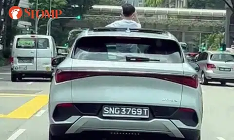 Boy stands with body sticking out of sunroof in moving car along Havelock Road: Is it legal?