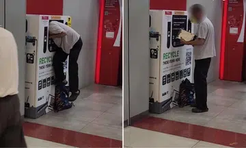man crawls into e-waste bin and retrieves tablet