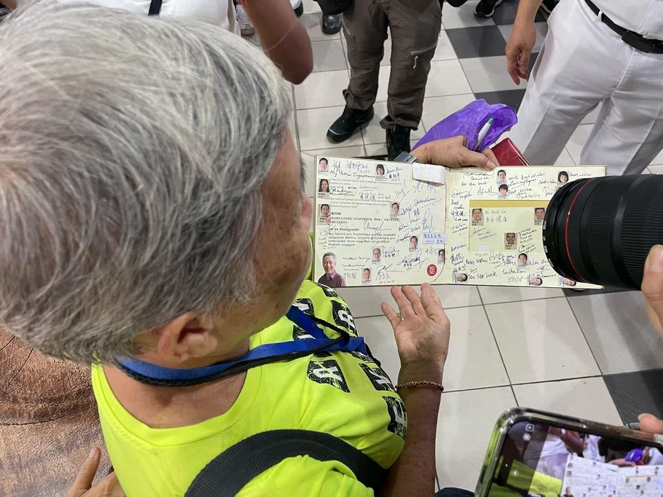 Madam Soh Siew Geok’s book is a patchwork of politicians’ faces and signatures.