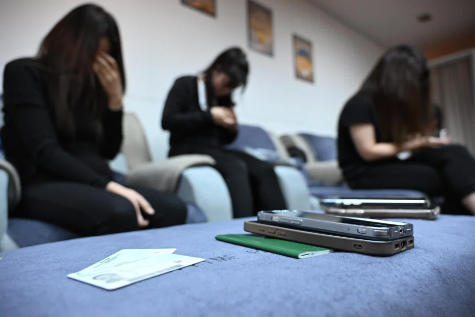 Phones, passports and work documents were seized from workers at a massage parlour in People's Park Centre. ST PHOTO: CHONG JUN LIANG