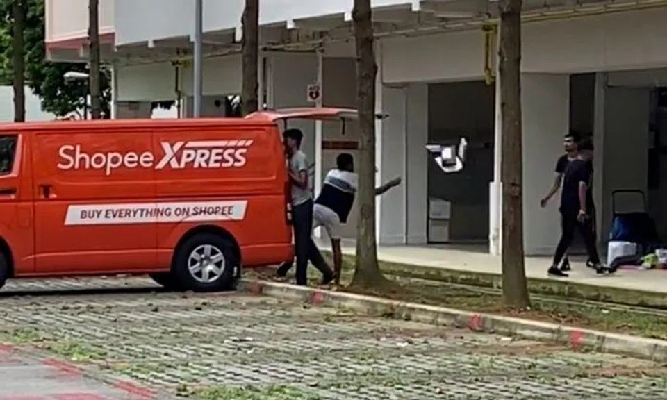The video shows two workers at the back of the parked van insouciantly throwing packages from the back of the vehicle to a third man who did not try very hard to catch them.