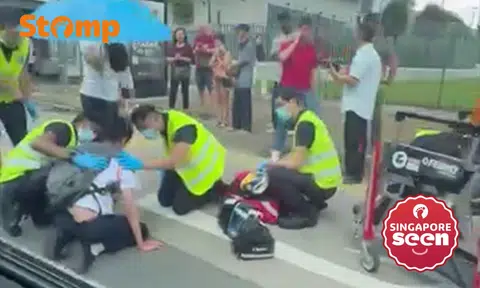 Man holds umbrella over 16-year-old boy after Toa Payoh accident, car driver assisting with investigations