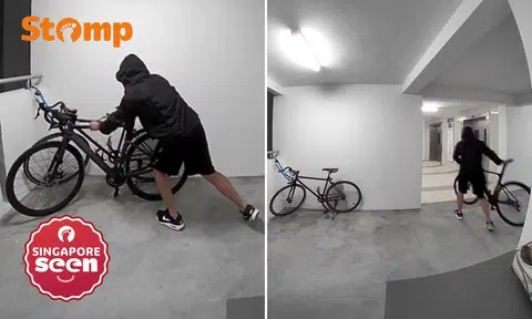 Hooded man taking bicycle from outside Yishun flat