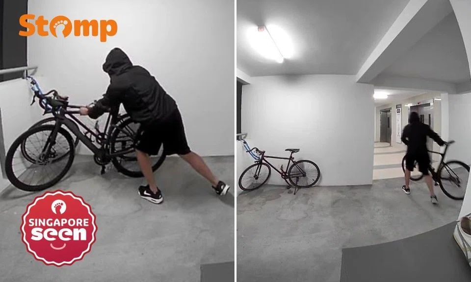Hooded man taking bicycle from outside Yishun flat