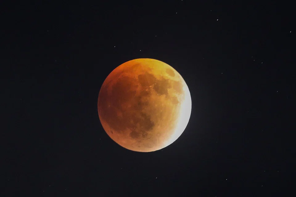 The blood moon hanging in the sky during a total lunar eclipse in Colombo, Sri Lanka, on Sept 7.