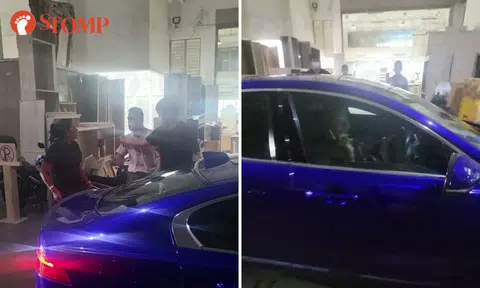 Jaguar driver blares horn, then rages at workshop owner who knocked on her car to check if she is alright