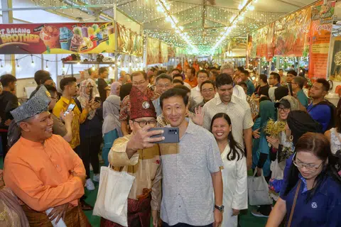 Health Minister Ong Ye Kung and fellow Sembawang GRC MPs (behind Mr Ong) Mariam Jaafar, Lim Wee Kiak (partially hidden) and Vikram Nair at the launch of Bazar Raya Utara@Woodlands on Feb 23.