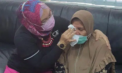 A CDE case officer wiping away Ms Sugiyem Samad Radimah's tears when they were speaking in September 2021. PHOTO: CENTRE FOR DOMESTIC EMPLOYEES