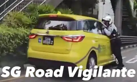 A Traffic Police officer was dragged along the road by a taxi for a few metres after the cabby closed the window on the officer's arm.