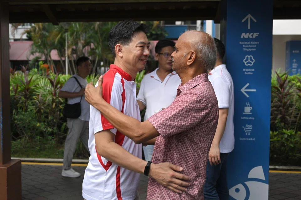 Nee Soon GRC MP Derrick Goh embracing a resident near Yishun Ring Road on April 22.