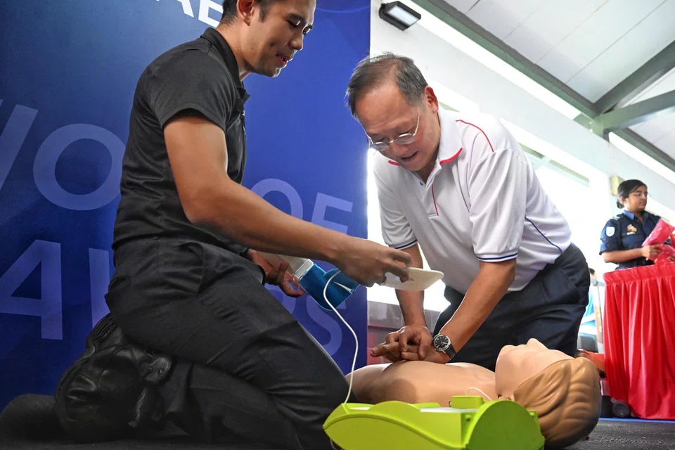 Manpower Minister Tan See Leng performing CPR on a mannequin at the Community Resilience Day event.