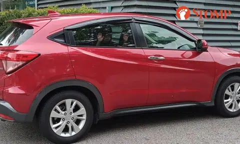 Illegally parked car blocking way beside Holland Village MRT station has child inside