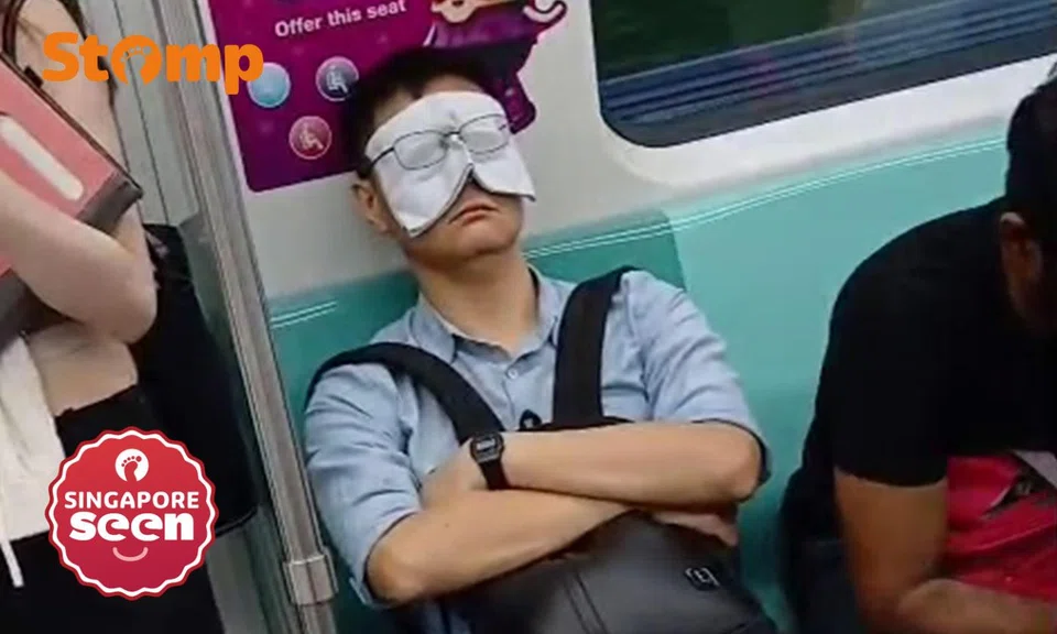 Handkerchief as eye mask on MRT train