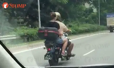 Female pillion rider goes helmet-less on PIE
