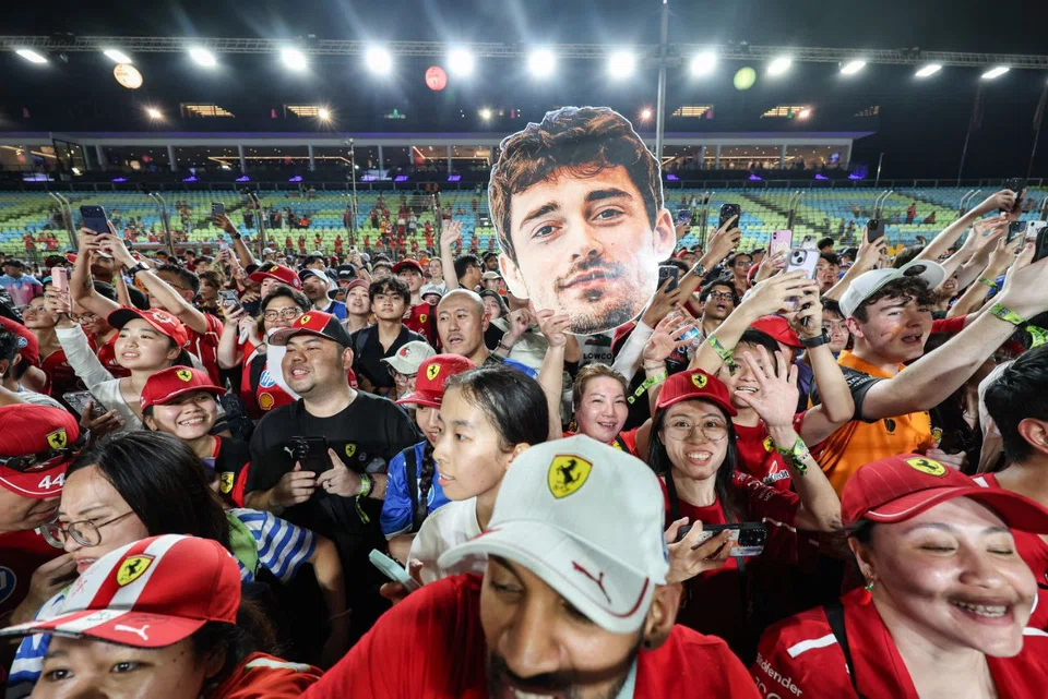 Ferrari fans gathering on the track after the Formula 1 Singapore Airlines Singapore Grand Prix night race at the Marina Bay Street Circuit on Oct 5.