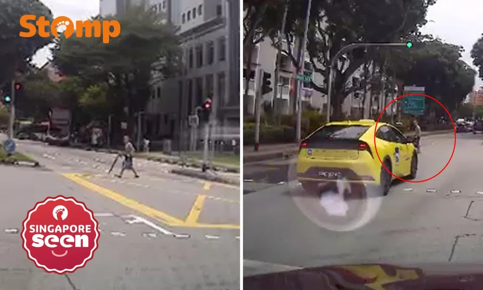 elderly woman jaywalks during busy traffic in Tampines