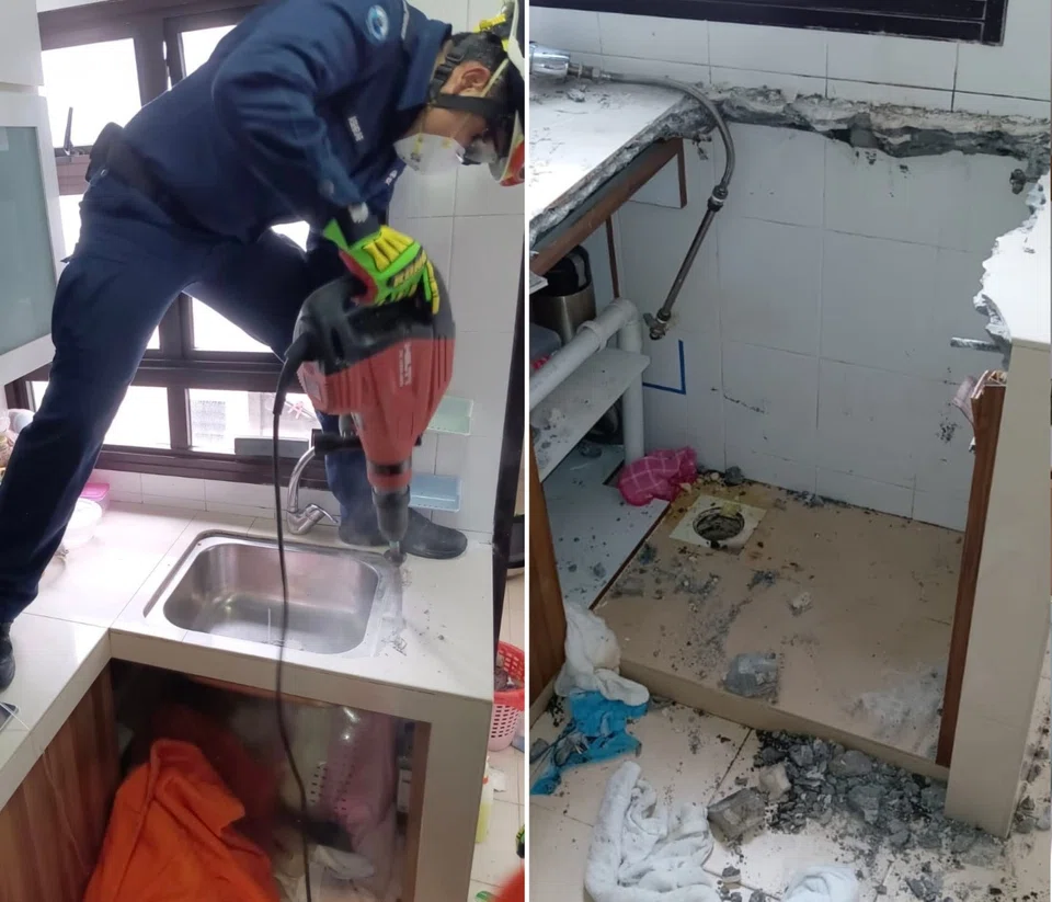 An electric breaker was used by a rescuer to remove the kitchen sink and cabinet housing the drain pipe.