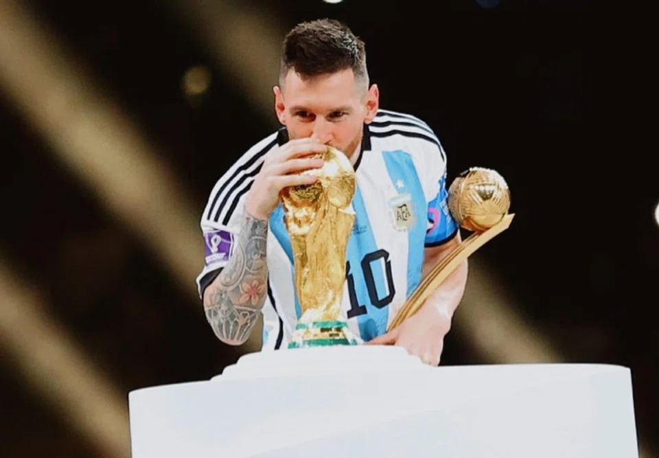 Lionel Messi kissing World Cup trophy