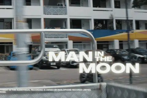 The music video opens with shots of HDB blocks.