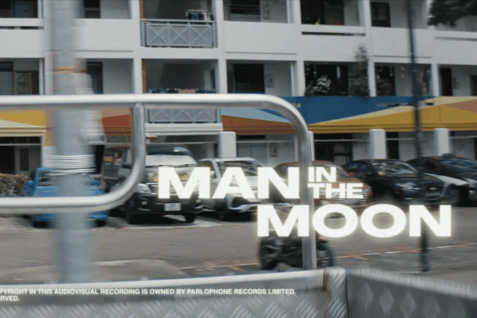 The music video opens with shots of HDB blocks.