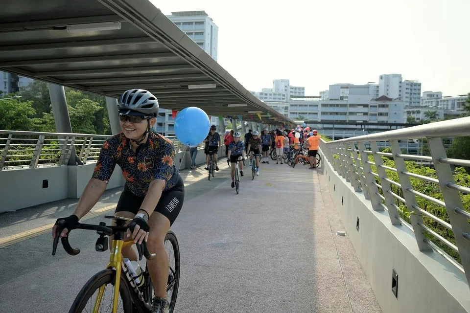 Cyclists riding across the new cycling bridge in Jurong West on Feb 15.