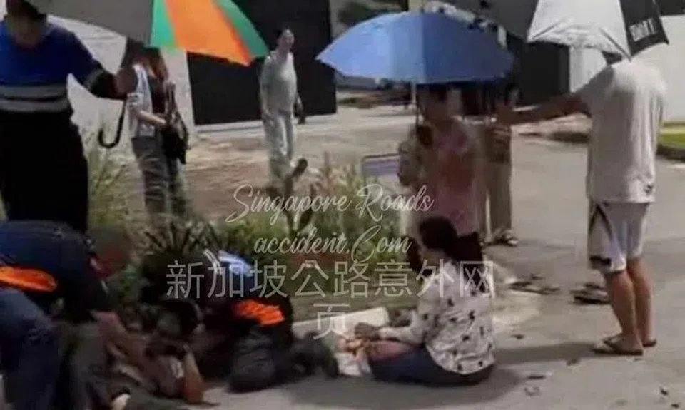 Several people can be seen sheltering and tending to the injured people. 