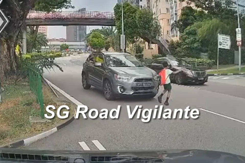 The boy is seen momentarily slowing down as he tilts his head towards ongoing traffic, with a car approaching. 