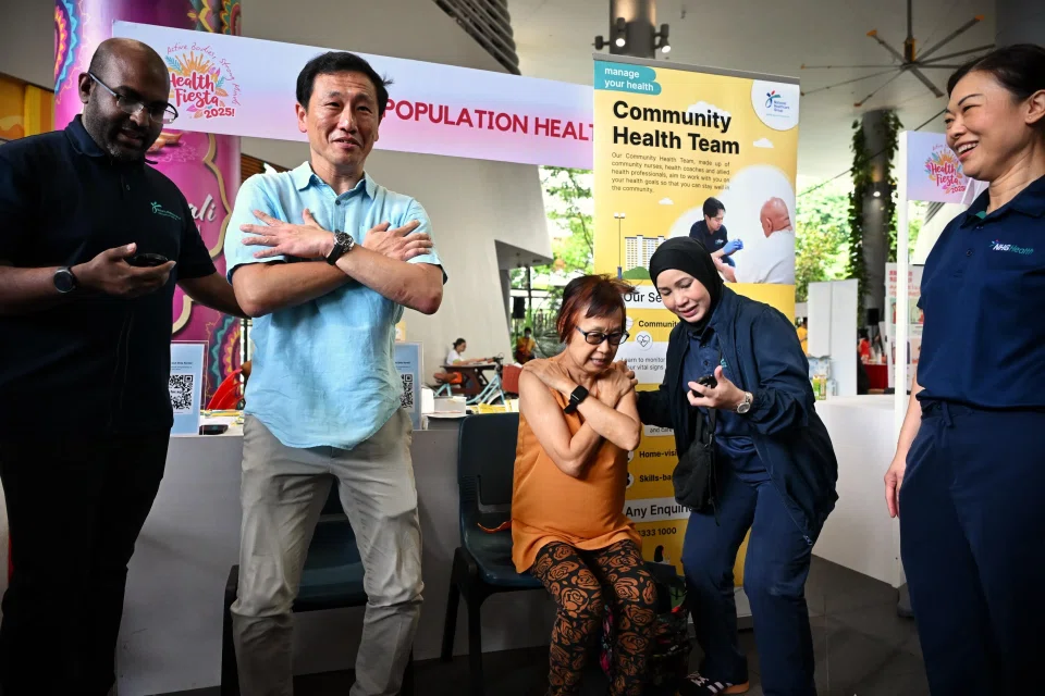 Health Minister Ong Ye Kung (second from left) participating in the chair rise test at a health fiesta held at Kampung Admiralty on Oct 12.