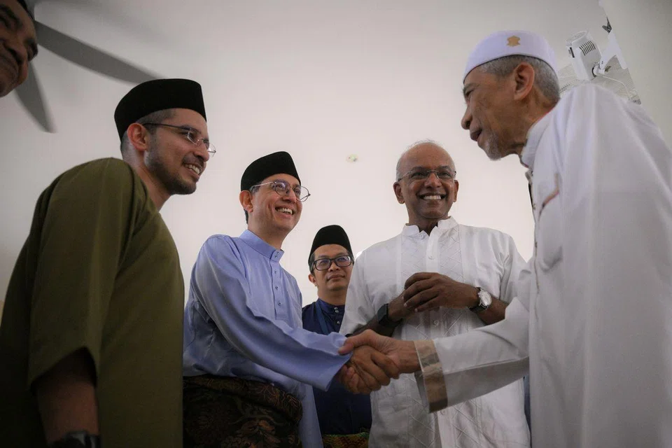 (From left) Nee Soon GRC MP Syed Harun Alhabsyi; Acting Minister-in-charge of Muslim Affairs Faishal Ibrahim; executive chairman of Masjid Darul Makmur Mohd Fairus Abdul Manaf; and Minister for Home Affairs K. Shanmugam greet a congregant after Hari Raya Aidiladha prayers.
