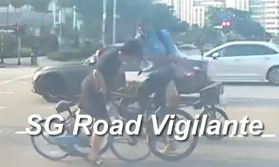 The cyclist slapped the boy on the face. 