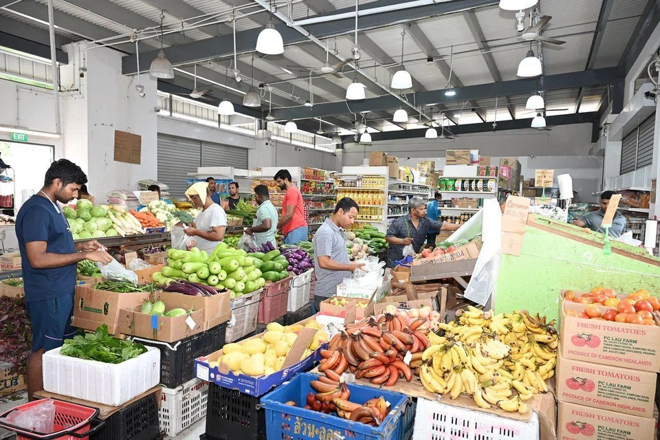 Migrant workers buying their groceries at the minimart in Cochrane Recreation Centre on Feb 16.