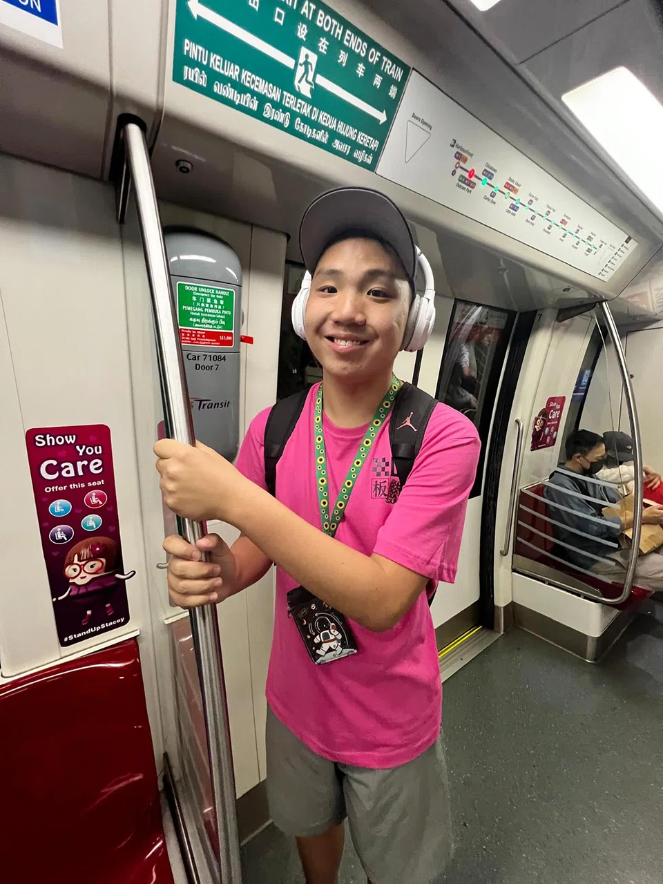 On public transport, Wallace Tan, who is triggered by sounds such as babies crying, wears headphones and has his family's helper by his side.