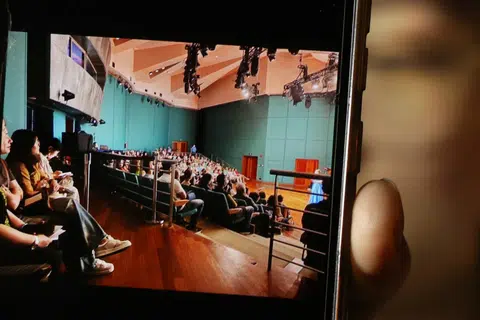 The group ended up in temporary back-row seats after entering the venue.