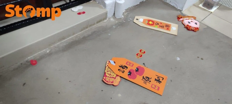 Pieces of CNY decoration on the floor in front of the Stomper's door